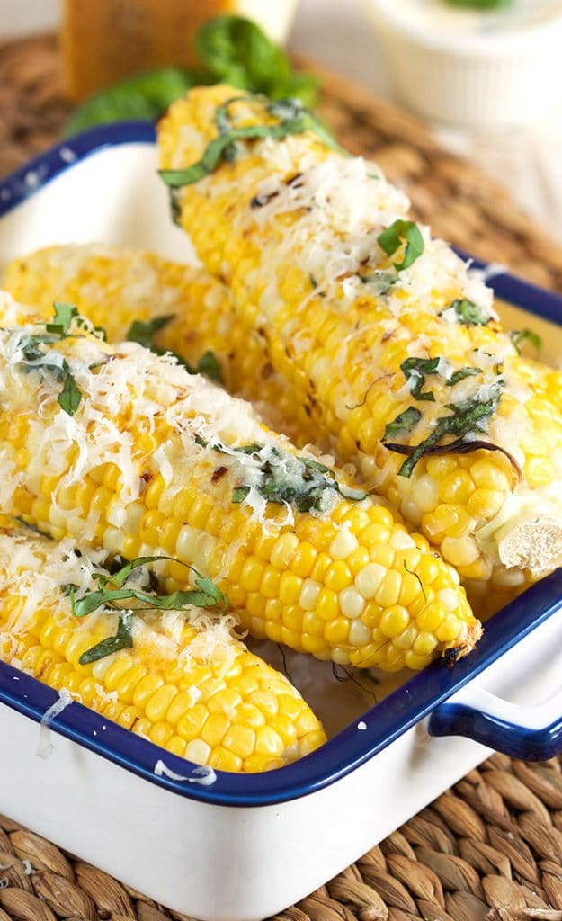 Super easy crowd pleaser, Basil Parmesan Grilled Corn on the Cob is the perfect summer side dish! | TheSuburbanSoapbox.com