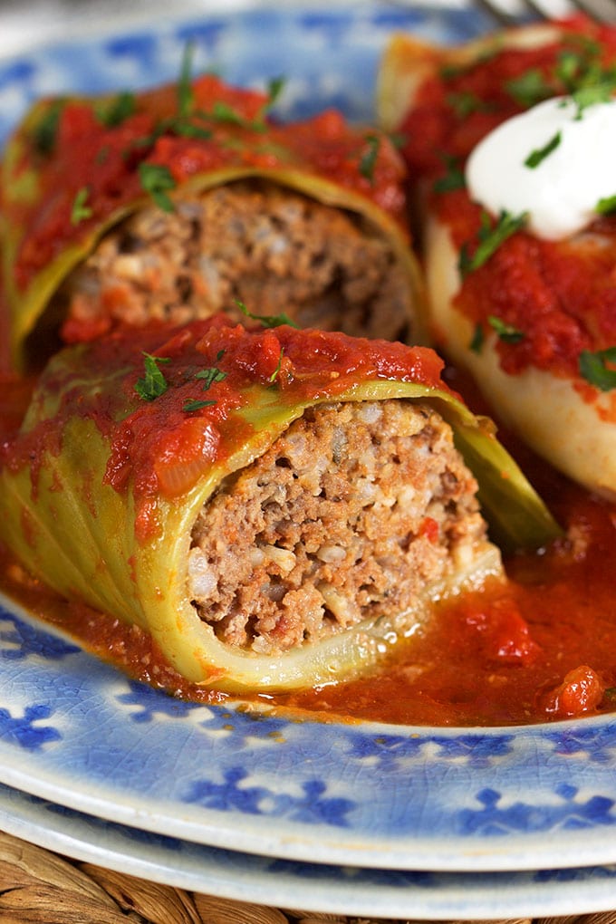 close up of the inside of a stuffed cabbage roll on a blue plate.