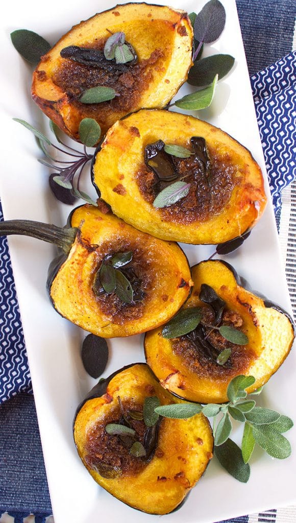 Quick and easy, Roasted Amaretto Gingersnap Acorn Squash is a festive side dish that's always a huge hit. Topped with a sweet/savory butter, this recipe is always a winner! TheSuburbanSoapbox.com