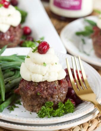 Mini Meatloaf Muffin on a white plate with a gold fork.