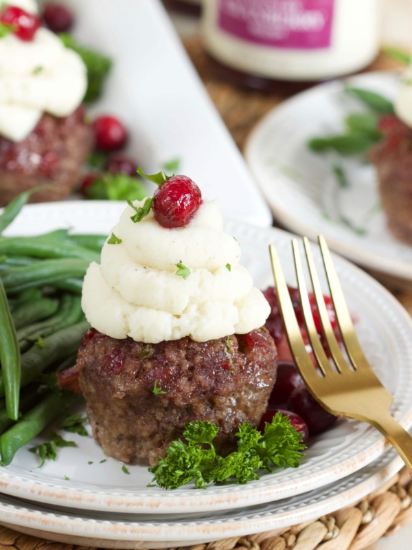 Mini Meatloaf Muffin on a white plate with a gold fork.