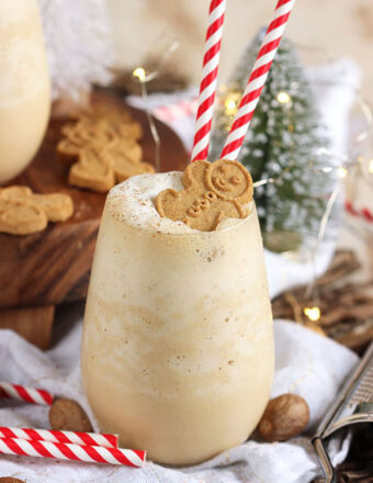 Gingerbread cheesecake smoothie with bottle brush tree in the background.