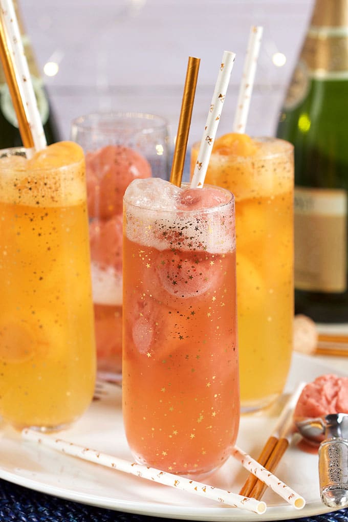 Fruity and festive, this Easy Mimosa Float Recipe is made with orange sorbet and champagne for a fun cocktail fit for any brunch celebration! | TheSuburbanSoapbox.com