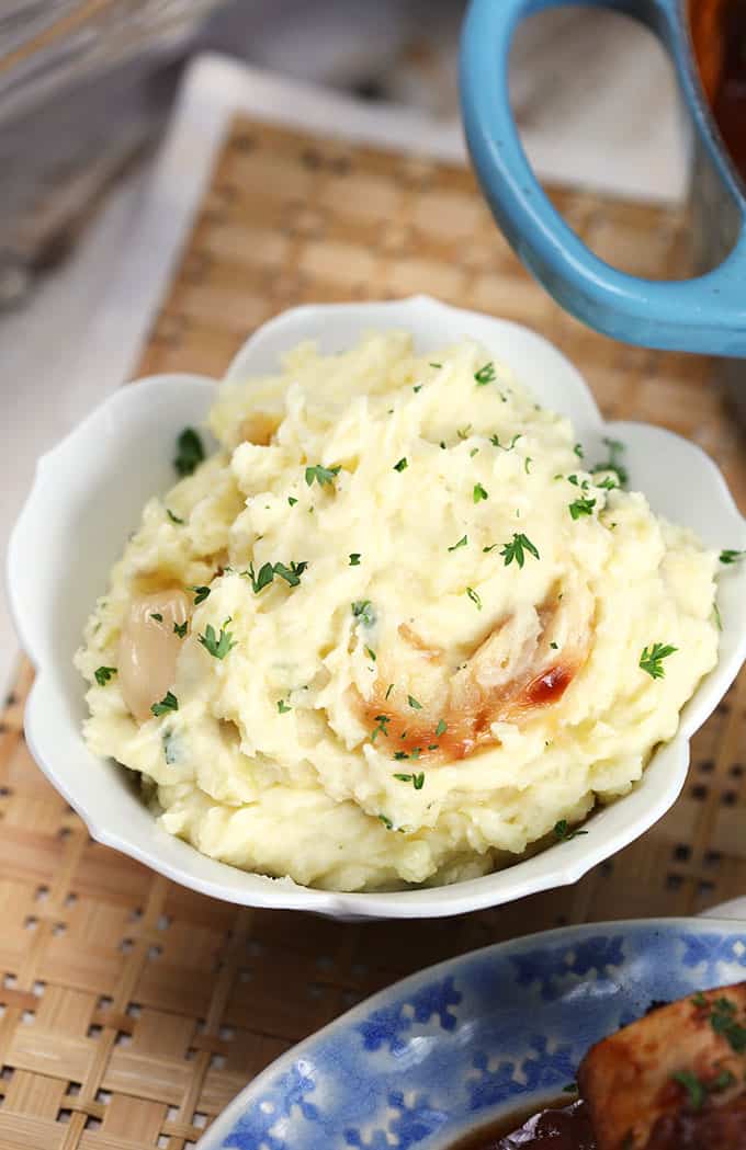 Roasted Garlic Mashed Potatoes in a white bowl from TheSuburbanSoapbox.com