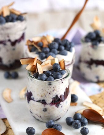 Blueberry coconut overnight oats in Weck jars with coconut and blueberries on top. From TheSuburbanSoapbox.com