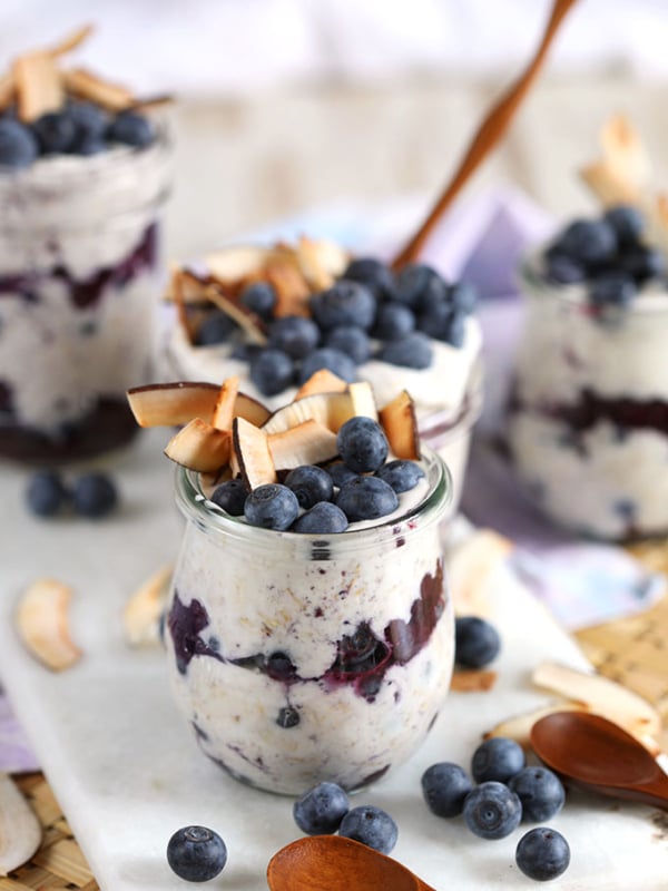 Blueberry coconut overnight oats in Weck jars with coconut and blueberries on top. From TheSuburbanSoapbox.com