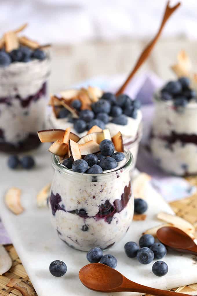 Blueberry coconut overnight oats in Weck jars with coconut and blueberries on top. From TheSuburbanSoapbox.com