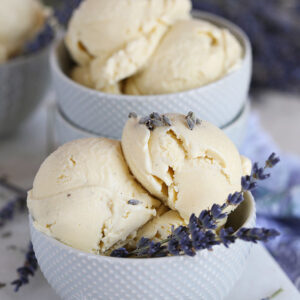 Lavender Ice Cream Recipe in a gray bowl with lavender buds from Thesuburbansoapbox.com
