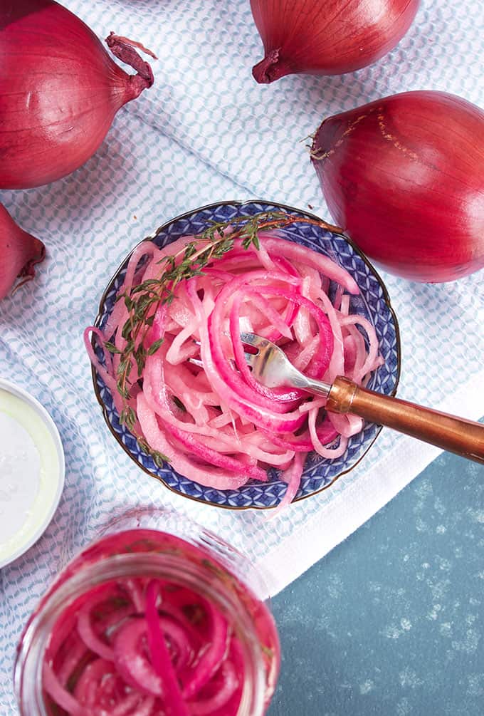Blue and white dish with pickled red onions and a copper fork from TheSuburbanSoapbox.com