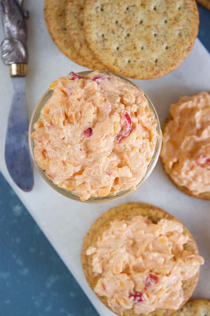 Pimento Cheese in a mason jar with a spreader and crackers on a marble board from TheSuburbanSoapbox.com