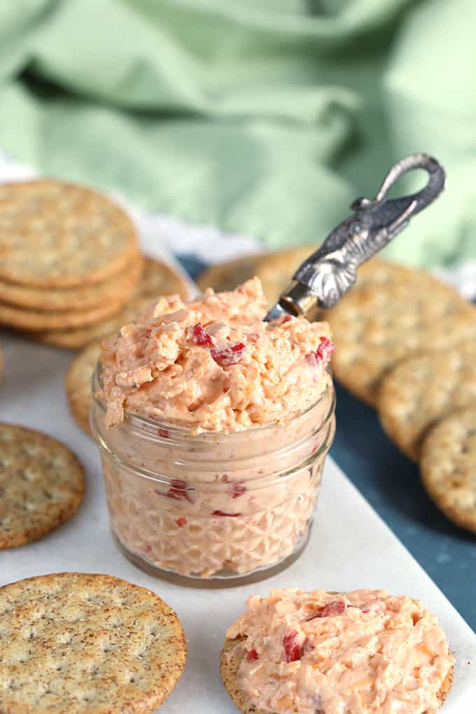 Pimento Cheese in a mason jar with a silver spreader and crackers from TheSuburbanSoapbox.com