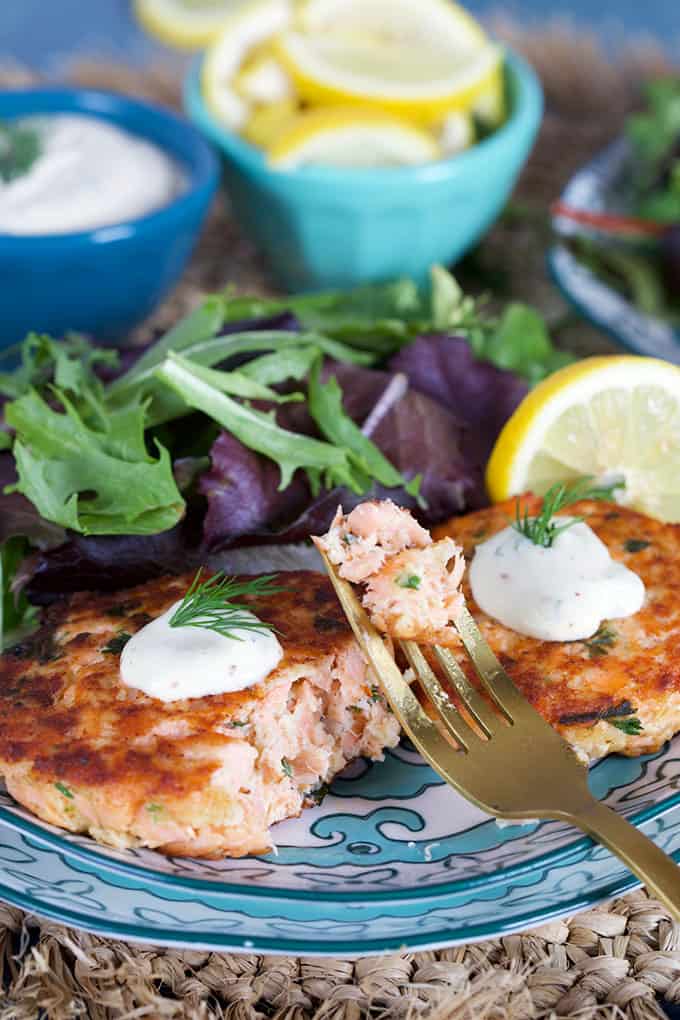Salmon Cake recipe on a decorative plate with a fork and lemons