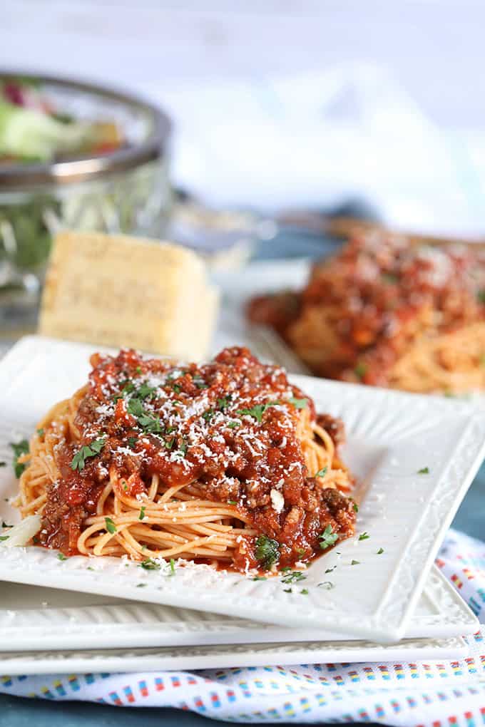 Spaghetti with Easy Italian Meat Sauce on a white plate with a blue background from TheSuburbanSoapbox.com