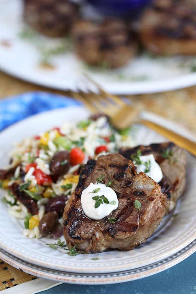 Grilled Balsamic Lamb Chops with Herbed Goat Cheese Sauce on a greek orzo salad from TheSuburbansoapbox.com