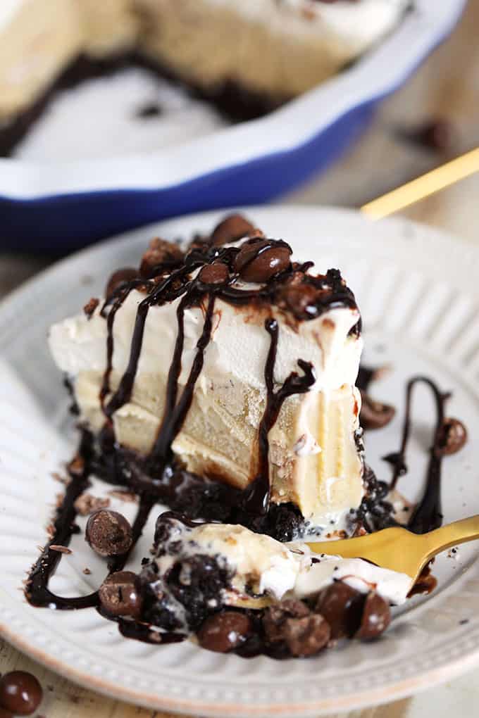 Slice of Frozen Mudslide Pie on a white plate with a gold fork from TheSuburbansoapbox.com