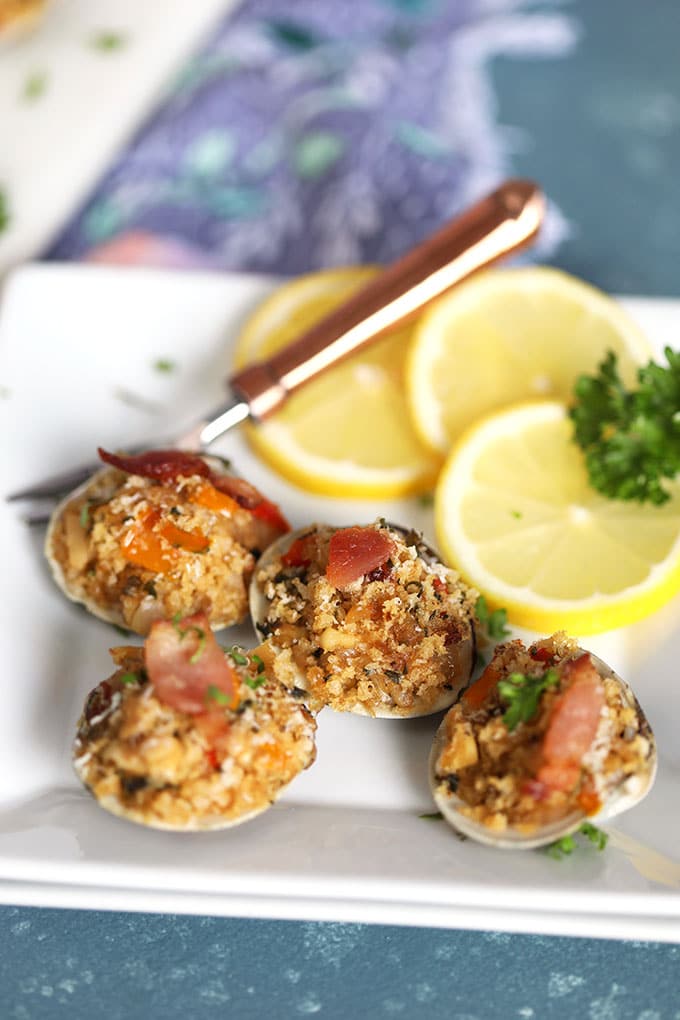 Clams Casino on a white plate with a copper fork from Thesuburbansoapbox.com