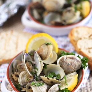 Grilled clams with lemon wedges in a white ramekin. From TheSuburbanSoapbox.com