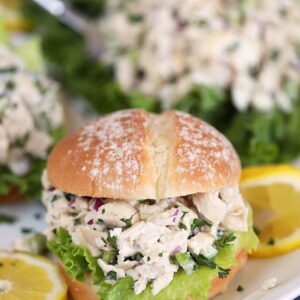 Lemon Tarragon Chicken Salad on a white roll with lettuce and lemon slices from TheSuburbanSoapbox.com