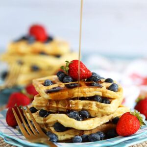 Stack of waffles with maple syrup being drizzled from TheSuburbanSoapbox.com