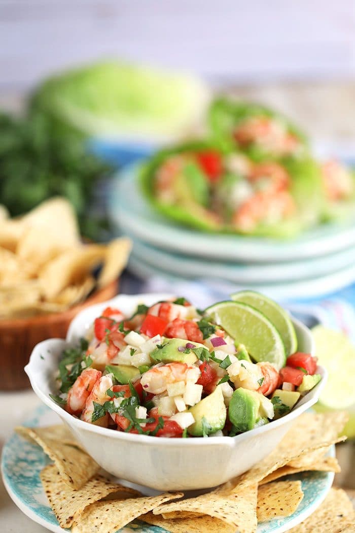 Shrimp ceviche with avocado in a white bowl with chips from TheSuburbanSoapbox.com