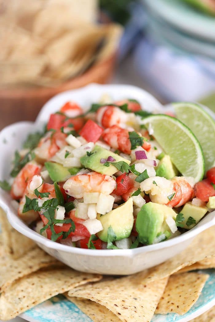 Easy Shrimp Ceviche in a white bowl with limes from TheSuburbanSoapbox.com