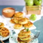 Fried Green Tomatoes on an aqua splattered plate with a wood fork on a blue background from TheSuburbanSoapbox.com