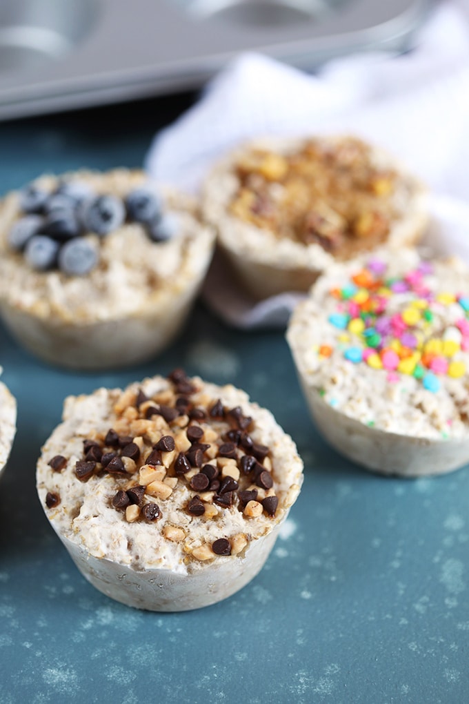 Freezer Steel Cut Oatmeal in muffin cups with toppings like blueberries, sprinkles and chocolate from TheSuburbanSoapbox.com