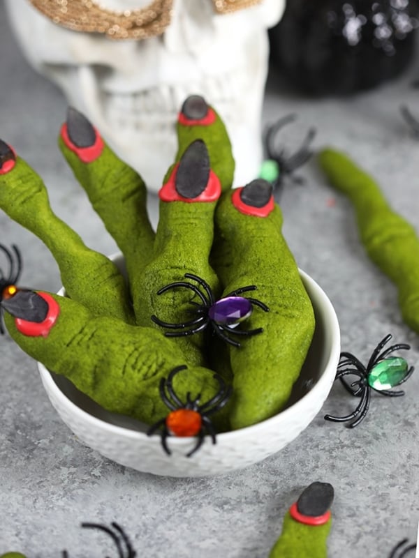 Close up of witch finger cookies in a white bowl.