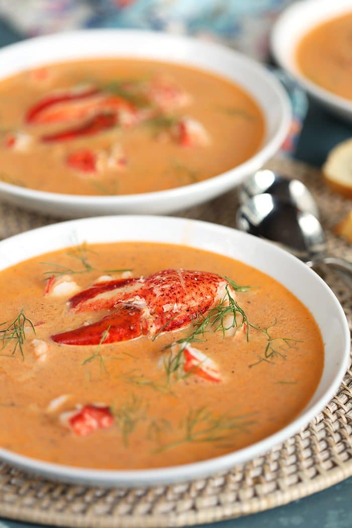 Two white bowls filled with Lobster Bisque.