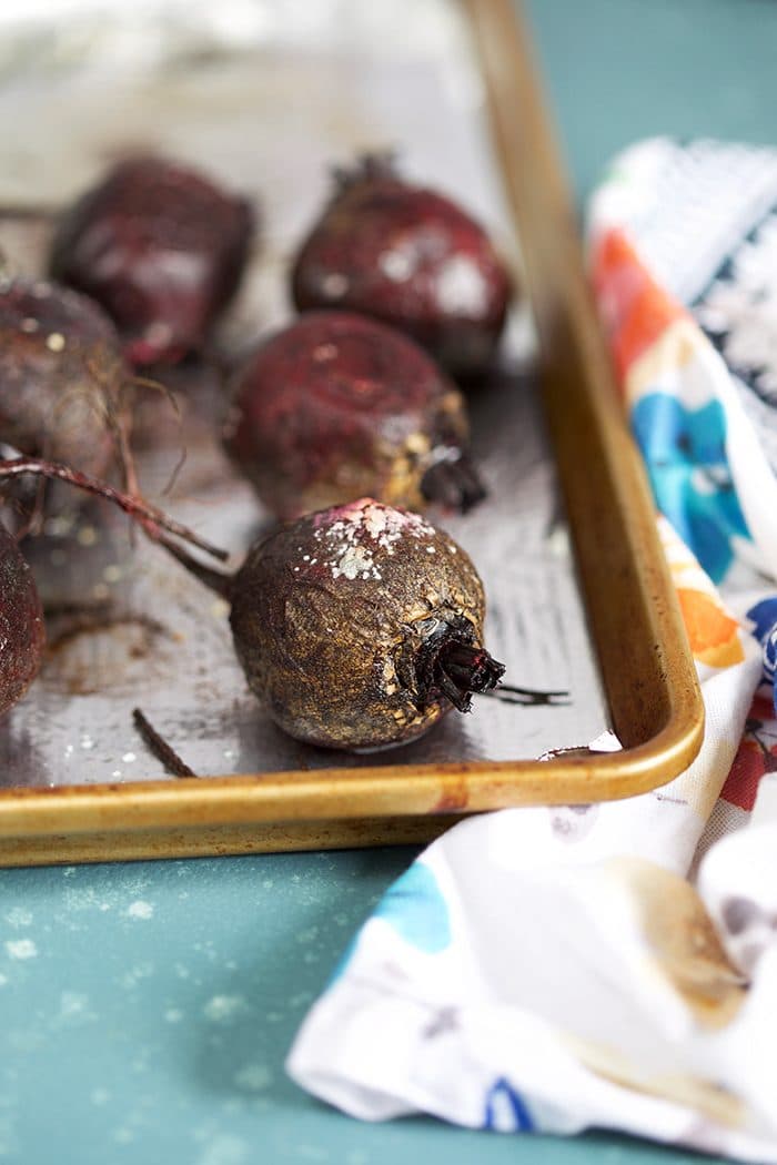 Oven roasted beets on a baking sheet.
