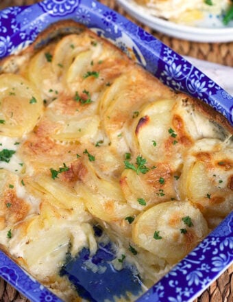 Homemade scalloped potatoes in a blue and white baking dish.