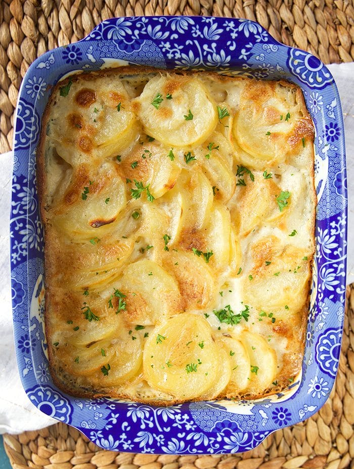 Overhead shot of easy Scalloped Potatoes in a blue and white baking dish.