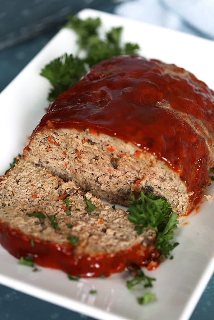 Double Glazed Turkey meatloaf on a white platter with parsley.