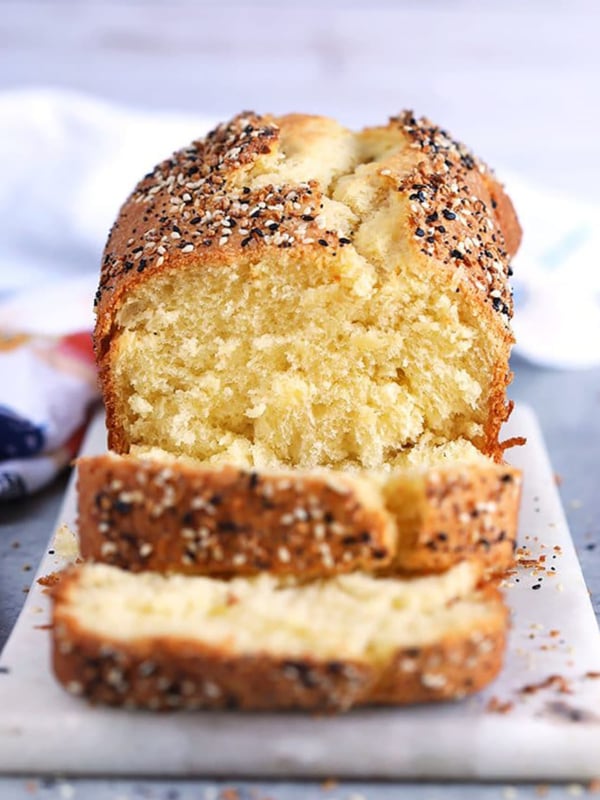 Everything Bagel Brioche on a marble board with two slices cut off and stacked in front.