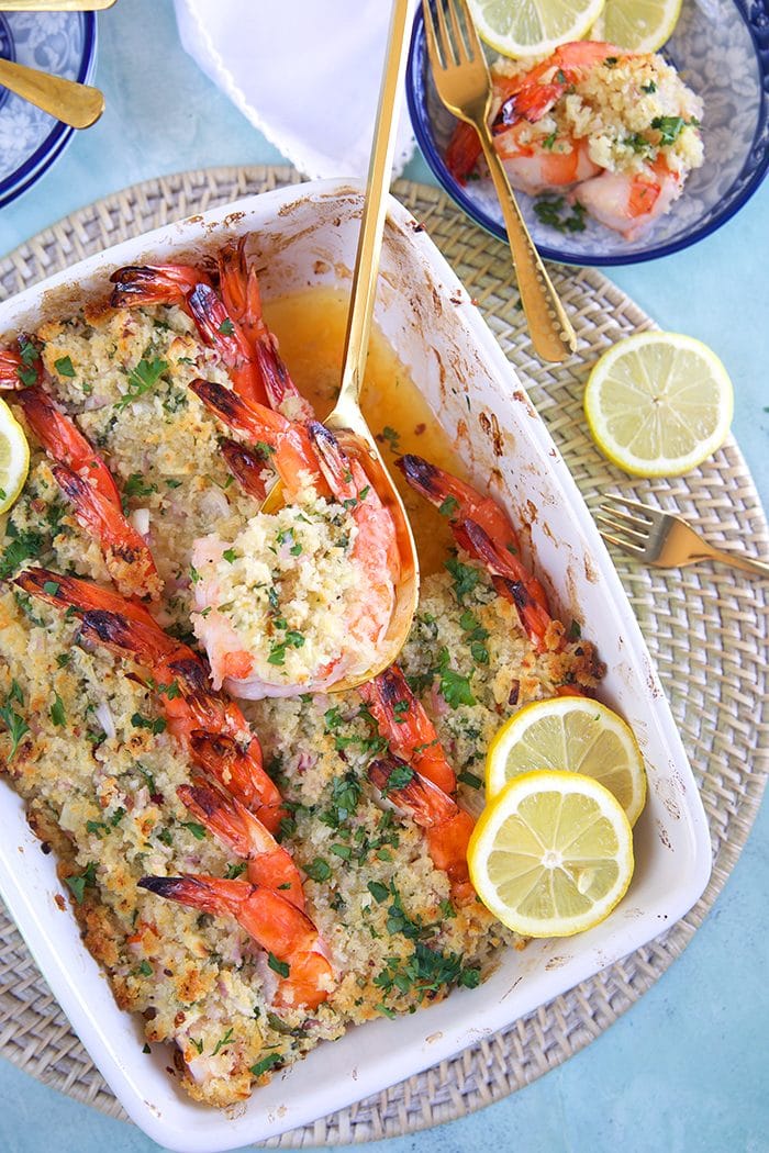 Baked Shrimp Scampi recipe overhead shot in a baking dish with a gold serving spoon.