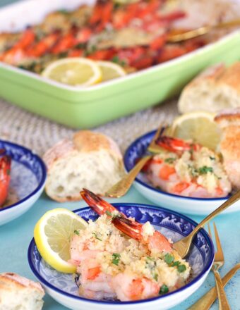 Baked Shrimp Scampi on a blue and white plate with a gold fork.