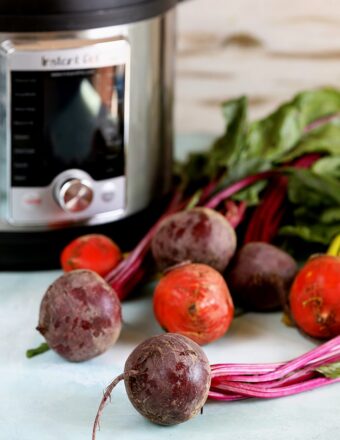 Instant Pot with fresh beets in front.