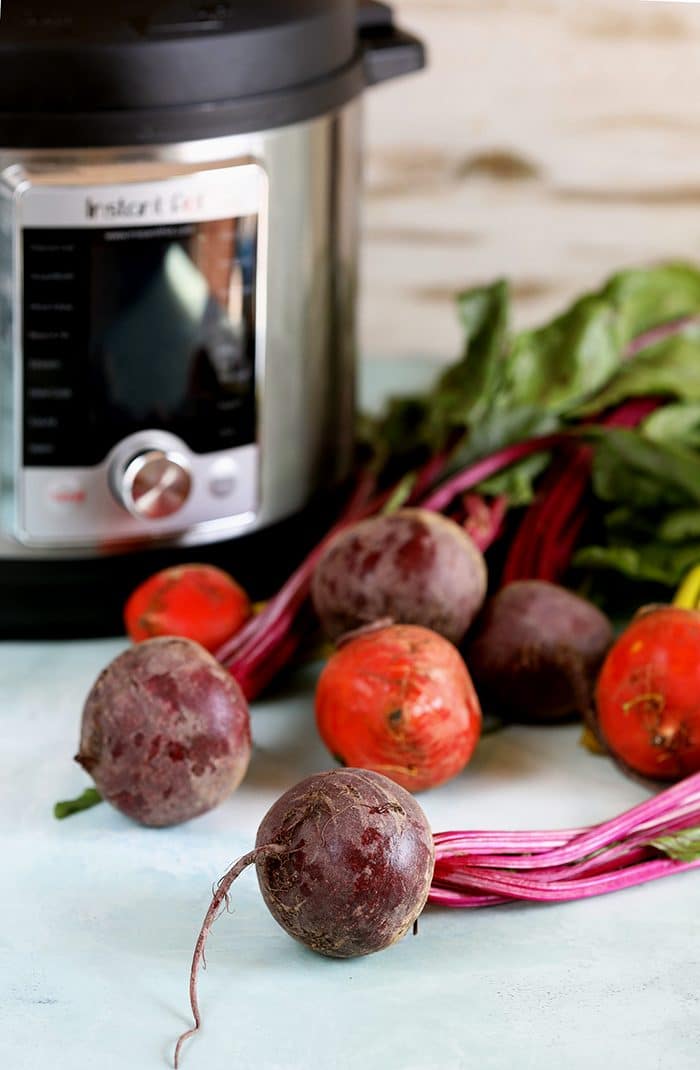 Instant Pot with fresh beets in front.