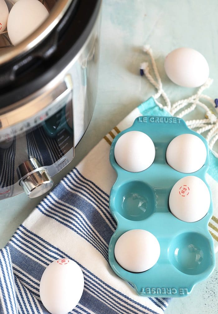 Eggs in a blue egg crate with an Instant Pot on the side.