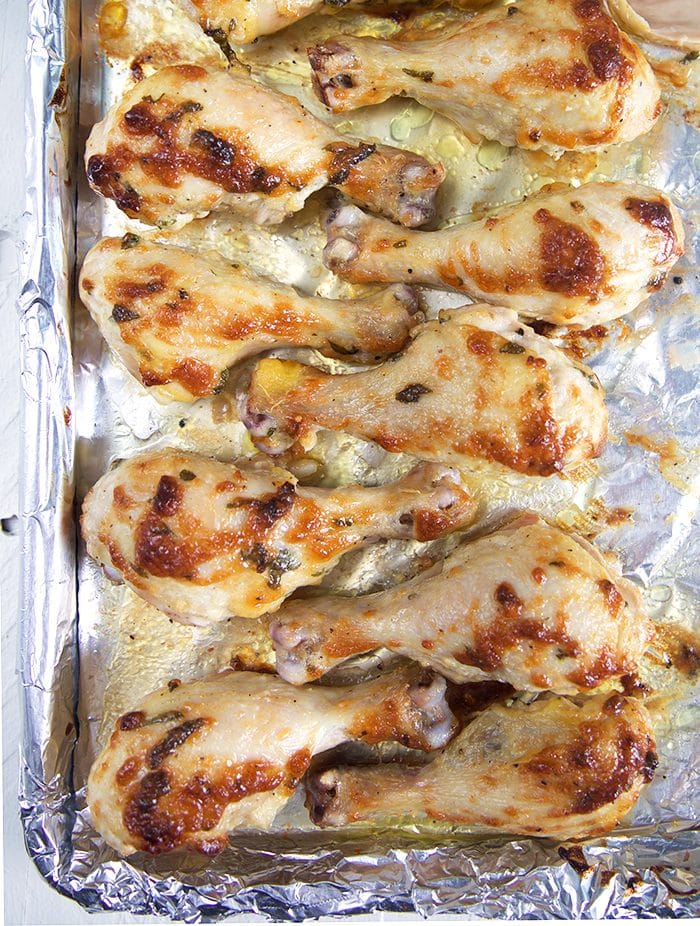 Baked Chicken Drumsticks on a baking sheet lined with foil.