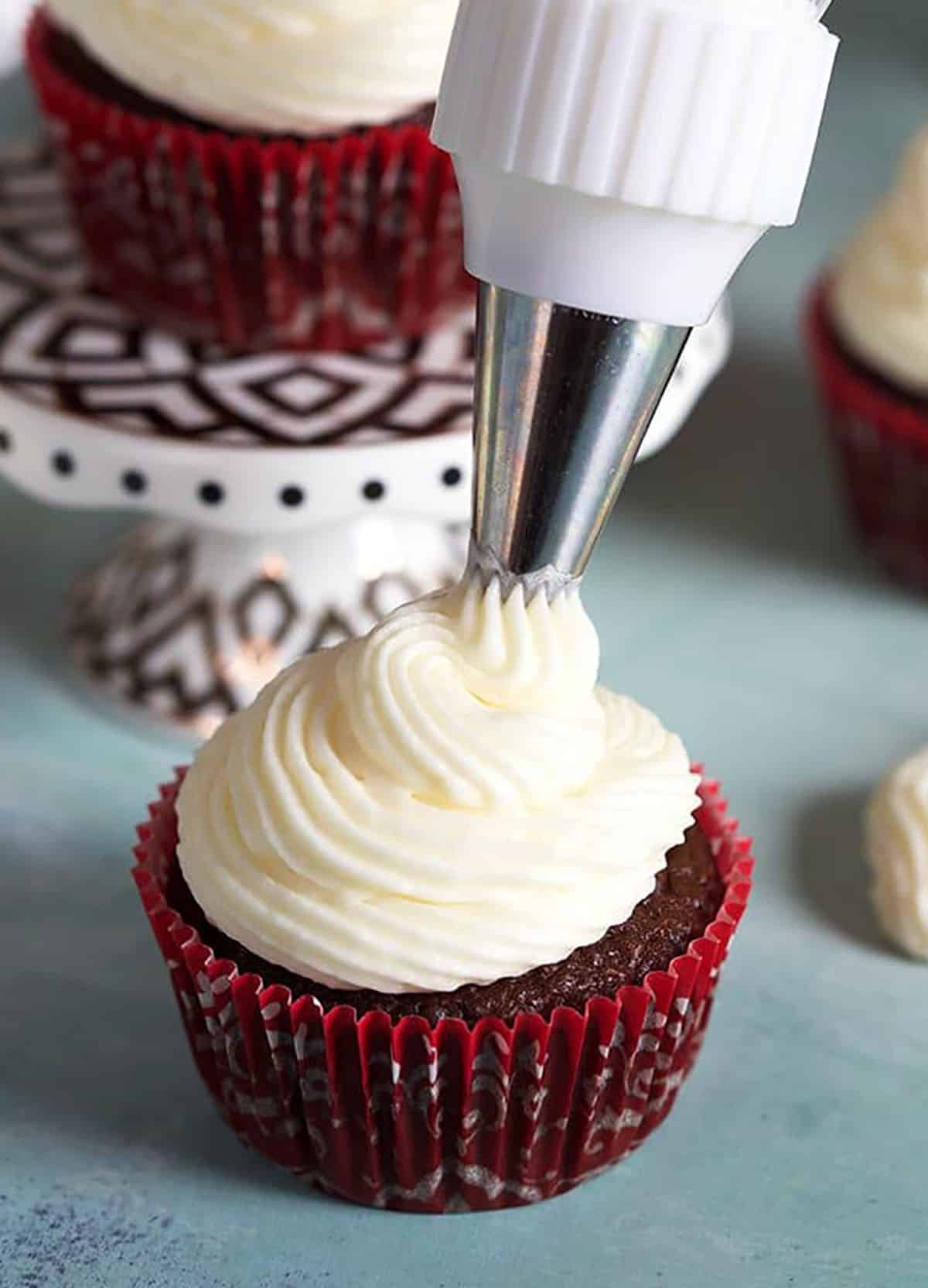 Chocolate cupcakes with whipped cream cheese frosting.
