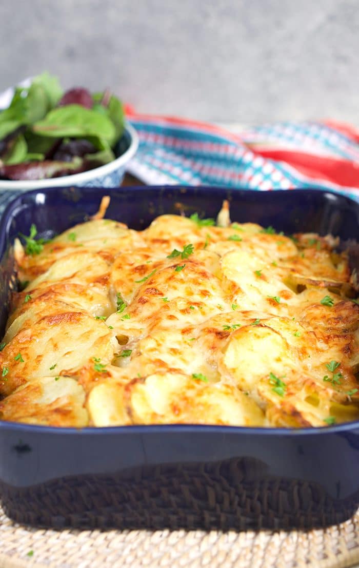Scalloped Potatoes with ham in a blue casserole dish.