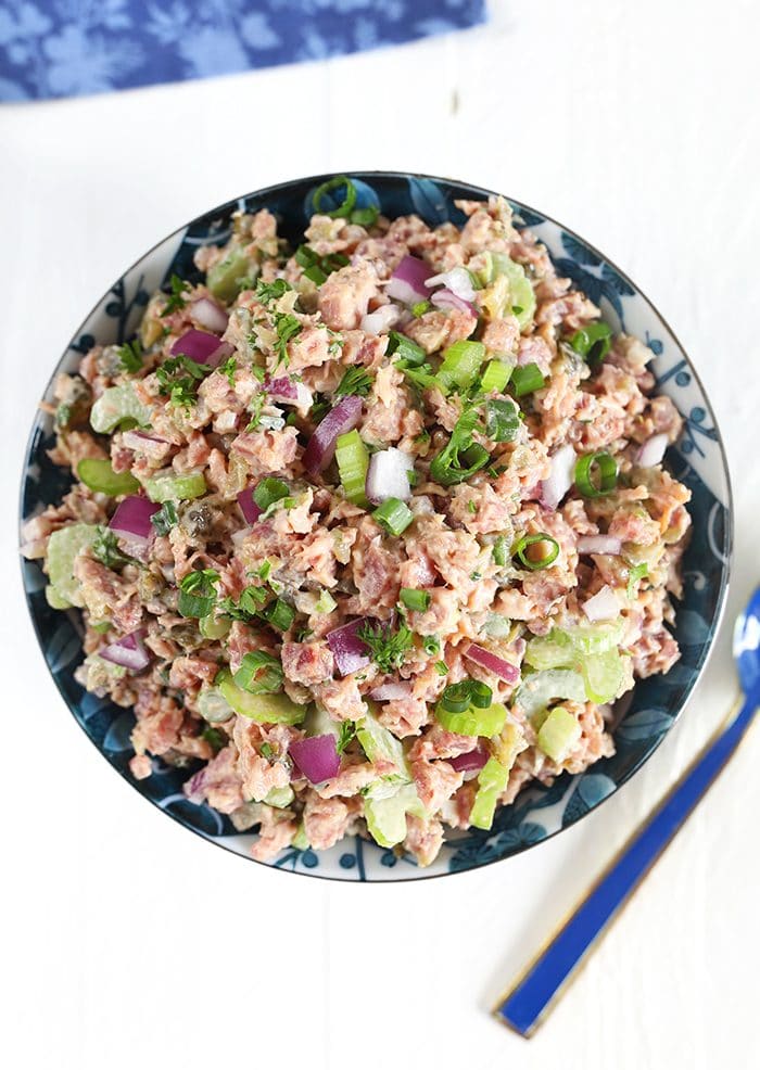 Overhead shot of Southern Ham Salad in a blue and white bowl on a white background.