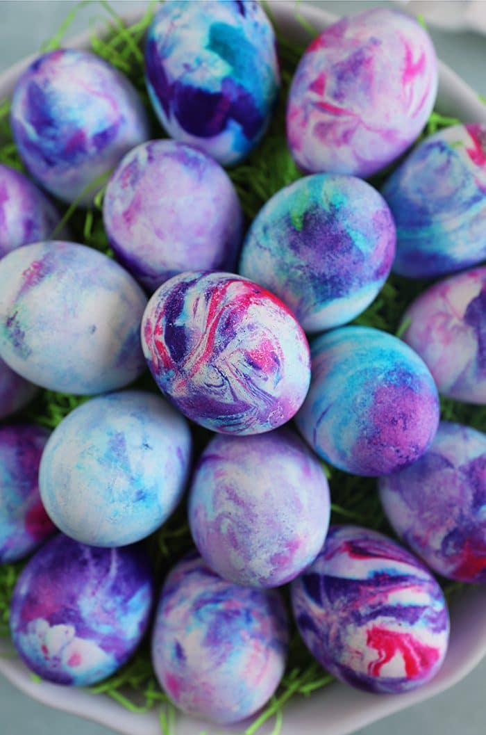 Overhead shot of whipped cream dyed easter eggs.