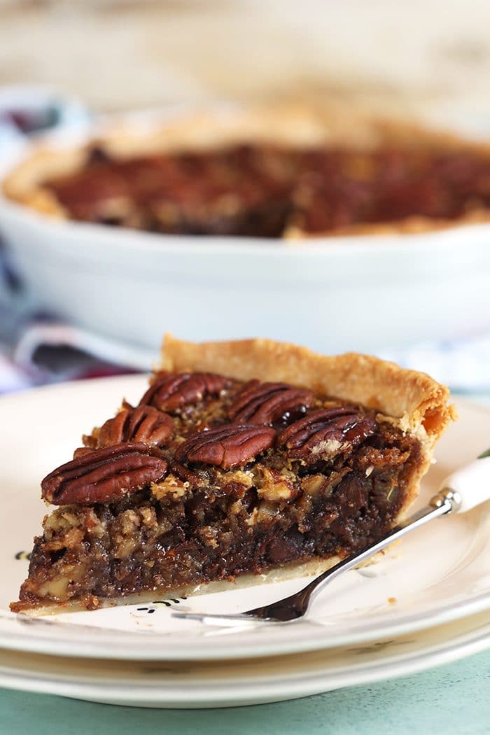 Close up of pecan pie on a white plate.