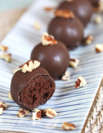 Dark Chocolate Truffles spiked with bourbon an a blue and white striped platter.