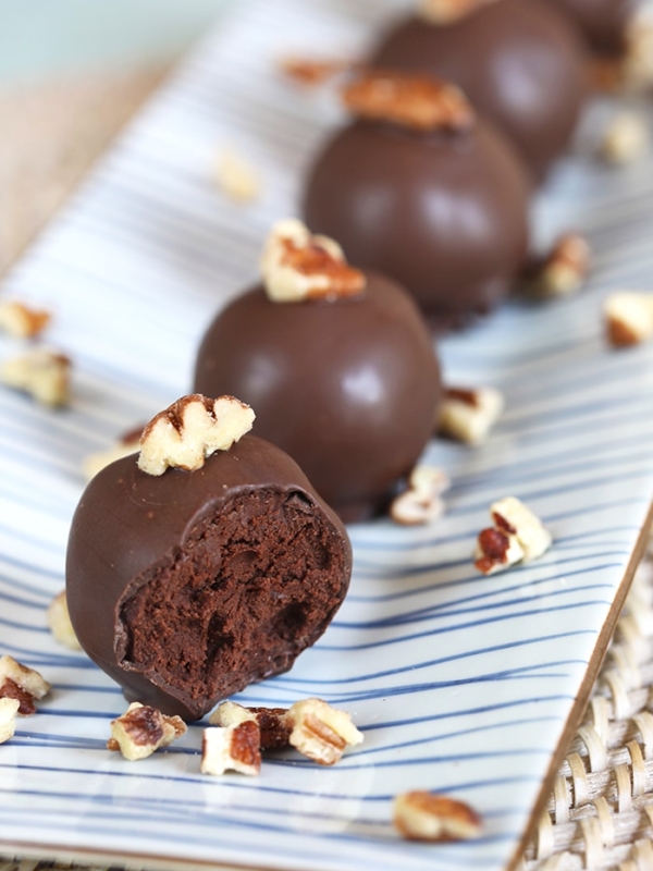 Dark Chocolate Truffles spiked with bourbon an a blue and white striped platter.