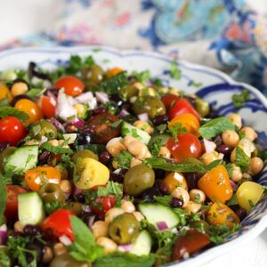 Close up of Mediterranean Chickpea Salad in a blue and white bowl.