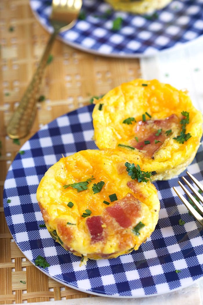 Egg muffin cups on a gingham plate.