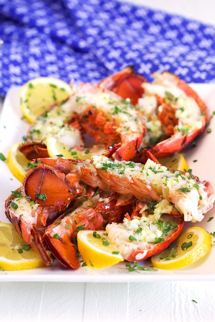 Grilled Lobster Tails on a white platter.